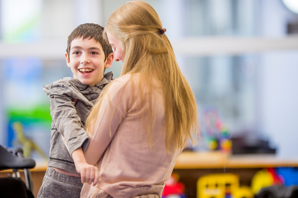 Caregiver Helping a Disabled Child